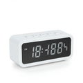 Rectangular digital alarm clock with a white plastic casing. The display shows an Royalty Free Stock Photo