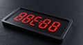 Rectangular digital clock featuring red LED numbers on a black background, Royalty Free Stock Photo