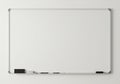 A rectangular dry-erase whiteboard with a silver frame mounted on a light-colored wall. Royalty Free Stock Photo