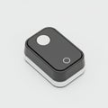 Rectangular electronic device with black and white casing, featuring a circular button Royalty Free Stock Photo