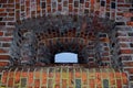 Rectangular embrasure with semicircular arch with recesses of several levels laid out of red brick which looks to piece of blue
