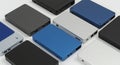 Rectangular external hard drives in various colors, like black, blue, and silver, are Royalty Free Stock Photo