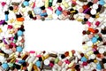 Rectangular frame of colorful pills on white background