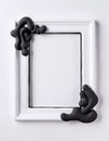 A rectangular frame features an intricate black design that flows and wraps around the corners, set against a plain Royalty Free Stock Photo