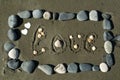 Beach stone frame with word Love on the sand Royalty Free Stock Photo