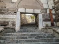Rectangular gate in a stone wall in the ancient Ankara Castle in capital of Turkey. Stone steps and a wall of multi-colored huge Royalty Free Stock Photo