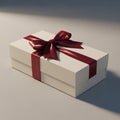 Rectangular gift box with a cream-white exterior, adorned with a glossy, deep red ribb Royalty Free Stock Photo