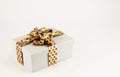 Rectangular gift box with golden ribbon and bow