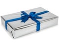 A rectangular gift box wrapped in shiny metallic silver paper with a decorative vibrant blue bow Royalty Free Stock Photo
