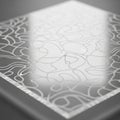 A rectangular glass panel features an intricate abstract pattern of curving lines and shapes. The Royalty Free Stock Photo