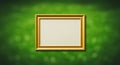 Rectangular, gold-colored picture frame set against a blurred green background. The Royalty Free Stock Photo