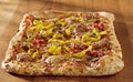 Rectangular gourmet pizza with sausage and colorfu Royalty Free Stock Photo