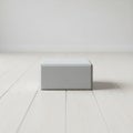 A rectangular gray block is centrally placed on a light colored wooden floor Royalty Free Stock Photo