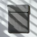 Rectangular gray fabric pouch, likely for electronics, on a white surface. The material
