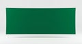 A rectangular green banner or cloth is centrally positioned against a light gray Royalty Free Stock Photo