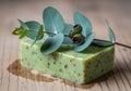 A rectangular, green soap bar is speckled with brown particles, Royalty Free Stock Photo