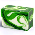 A rectangular isolated bar of handmade soap featuring green, black and white swirls