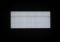 A rectangular LED panel with a grid of evenly spaced small white lights is illuminated Royalty Free Stock Photo