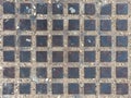 Sewer lid of forty-eight metallic squares for background