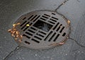 Rectangular and line-shaped openings on wet asphalt. Water flows Royalty Free Stock Photo