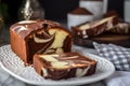 Rectangular marbled vanilla and chocolate pudding cupcakes with a chocolate bar and decorated with dried flowers and dusted with