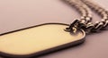 Rectangular metal dog tag with rounded edges attached to a thick, interlocking metal chain. The Royalty Free Stock Photo