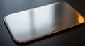 Rectangular metal plate with rounded corners on a dark surface. The plate has a Royalty Free Stock Photo