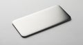 Rectangular metal plate with rounded edges placed on a smooth, light gray surface. The plate is Royalty Free Stock Photo