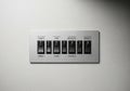 Rectangular metal switch panel with six labeled toggle switches. Royalty Free Stock Photo