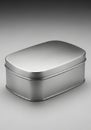 A rectangular metal tin box is shown on a gray background. The box has a brushed Royalty Free Stock Photo