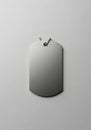 Rectangular metallic dog tag with rounded edges against a light gray background. Features a Royalty Free Stock Photo