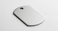 Rectangular metallic dog tag with rounded edges and a brushed texture, featuring a single hole near Royalty Free Stock Photo