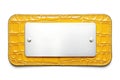 Rectangular metallic silver nameplate or name tag attached to yellow crocodile leather backing isolated on white background Royalty Free Stock Photo
