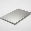 A rectangular, metallic steel plate rests on a plain white surface. The plate has a Royalty Free Stock Photo