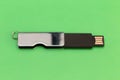 Rectangular metallic USB flash drive on a green background Royalty Free Stock Photo