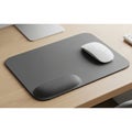Rectangular mouse pad on a light wood desk featuring a cushioned wrist rest Royalty Free Stock Photo