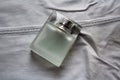 Rectangular perfume bottle on light grey jeans Royalty Free Stock Photo