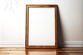 Rectangular picture frame mockup with wooden subframe on light wooden floor