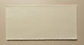 Rectangular piece of beige textile material on a similarly colored background. The Royalty Free Stock Photo