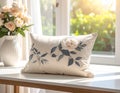 Rectangular Pillow with Floral Embroidery on Table by Window with Roses cushion cream Royalty Free Stock Photo