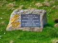 A rectangular plaque attached to a rock marks the graves of six of the crew who died when the brig Starke was shipwrecked