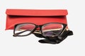 Rectangular plastic oversized eyeglasses with red glasses leather case  and black microfiber cleaning cloth isolated on a white Royalty Free Stock Photo