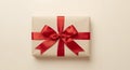 Rectangular Present, Wrapped in Beige Paper with a Red Ribbon and Bow, From Above. Royalty Free Stock Photo