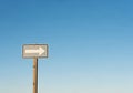 A rectangular road sign with a white right-pointing arrow is Royalty Free Stock Photo