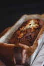 Rectangular ruddy metropolitan cake-bread in a metallic baking dish on a dark background. Close-up. View from above. Copy space