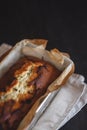 Rectangular ruddy metropolitan cake-bread in a metallic baking dish on a dark background. Close-up. View from above. Copy space Royalty Free Stock Photo