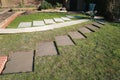 Rectangular sections cut into a lawn with concrete bases prepared for stepping stones. Royalty Free Stock Photo