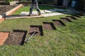 Rectangular sections cut into a lawn in preparation for concrete base and then stone stripping stone pathway installation. Royalty Free Stock Photo