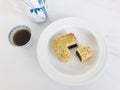 Red Bean Filling mooncake with a portion cutout, served with tea, on white marble background.