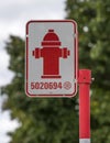 Rectangular sign on red pole displays a red fire hydrant icon in Montreal Royalty Free Stock Photo